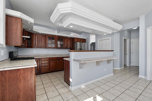 2155 Cottonwood Dr, Menasha, WI 54952 - kitchen featuring range hood, range with gas cooktop, stainless steel fridge, light countertops, and light tile patterned floors