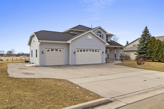 2155 Cottonwood Dr, Menasha, WI 54952 - traditional home with an attached garage, roof with shingles, and driveway