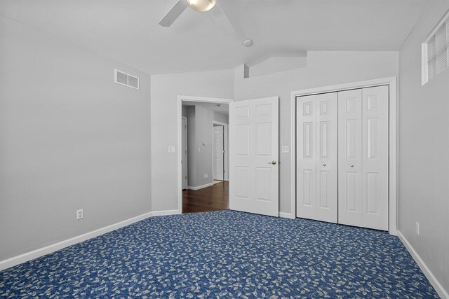 2155 Cottonwood Dr, Menasha, WI 54952 - unfurnished bedroom with visible vents, lofted ceiling, carpet floors, baseboards, and ceiling fan