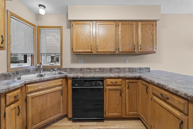 314 Castle Oaks Xing, Waunakee, WI 53597 - kitchen with black dishwasher, a sink, and brown cabinetry