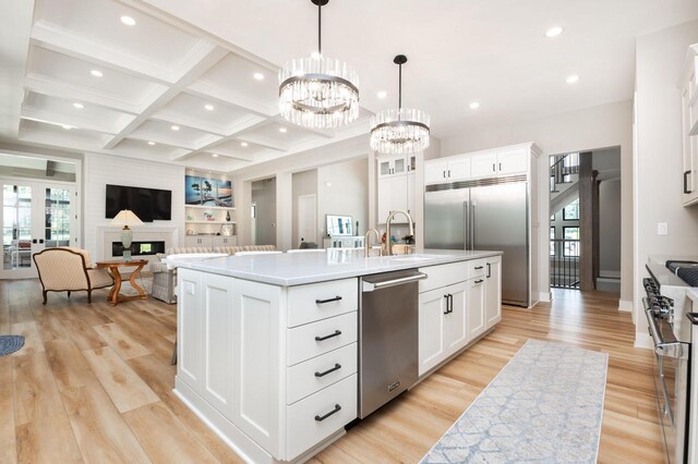 4779 Pine Meadows Ln, Hartland, WI 53029 - kitchen featuring beamed ceiling, high end appliances, coffered ceiling, and a wealth of natural light