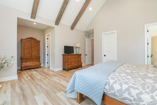 4779 Pine Meadows Ln, Hartland, WI 53029 - bedroom featuring light wood finished floors, visible vents, baseboards, beam ceiling, and high vaulted ceiling