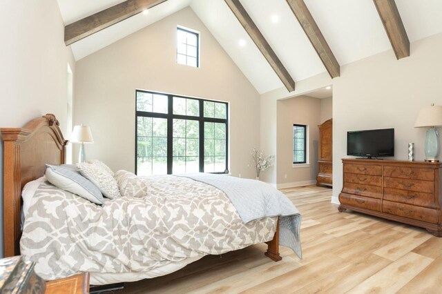 4779 Pine Meadows Ln, Hartland, WI 53029 - bedroom with beamed ceiling, baseboards, light wood-type flooring, and high vaulted ceiling