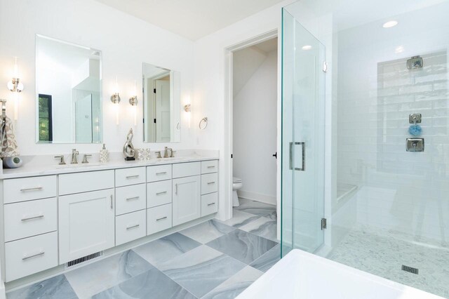 4779 Pine Meadows Ln, Hartland, WI 53029 - bathroom with a sink, toilet, marble finish floor, and a shower stall