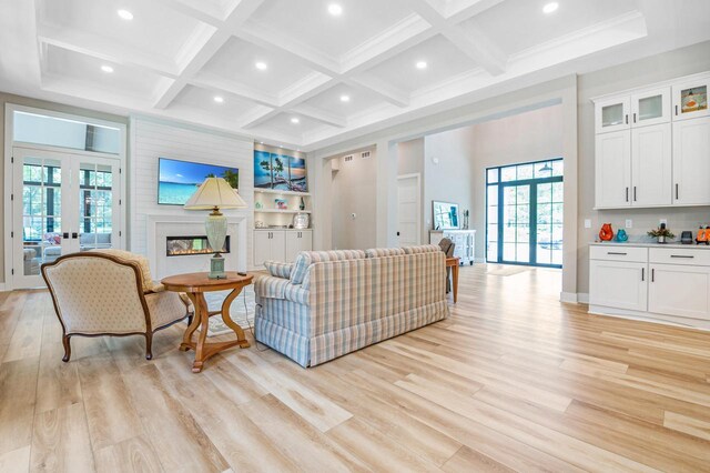 4779 Pine Meadows Ln, Hartland, WI 53029 - living area featuring a wealth of natural light, light wood-style floors, beam ceiling, and coffered ceiling