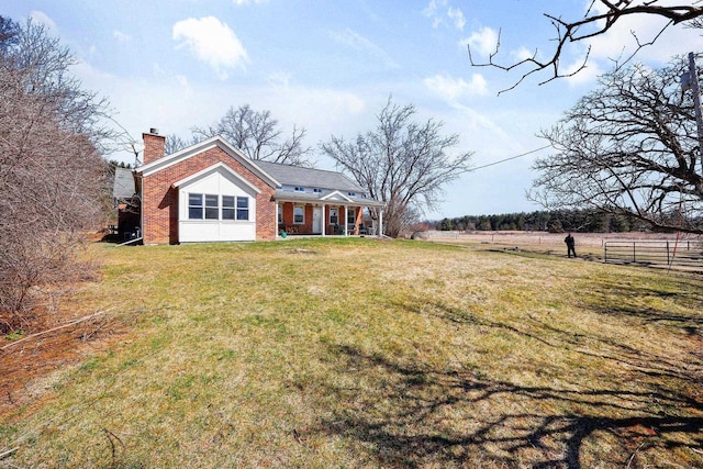 6112 County Road A, Brooklyn, WI 53521 - exterior space featuring a chimney, brick siding, fence, and a lawn