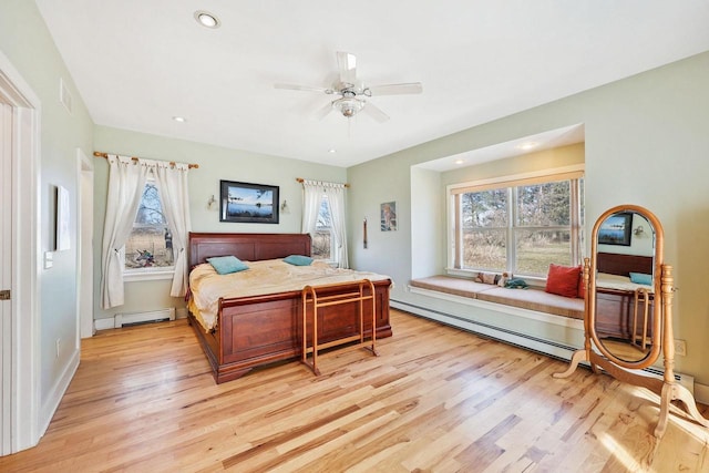 6112 County Road A, Brooklyn, WI 53521 - bedroom with light wood-style floors, a baseboard radiator, and multiple windows