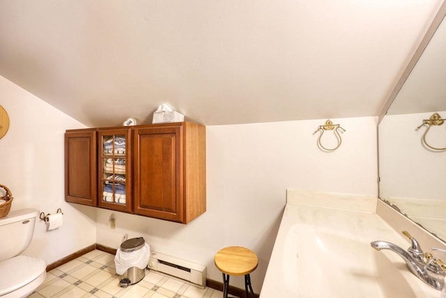 6112 County Road A, Brooklyn, WI 53521 - bathroom with baseboards, a sink, toilet, a baseboard heating unit, and lofted ceiling