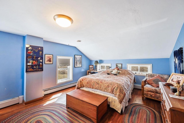 6112 County Road A, Brooklyn, WI 53521 - bedroom with baseboard heating, a baseboard heating unit, vaulted ceiling, and wood finished floors