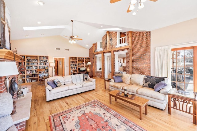 6112 County Road A, Brooklyn, WI 53521 - living area with high vaulted ceiling, a ceiling fan, visible vents, a skylight, and hardwood / wood-style flooring
