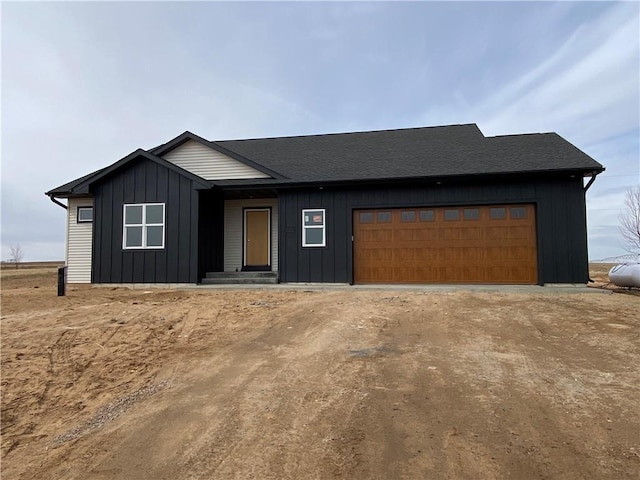 4607 933rd St, Elk Mound, WI 54739 - view of front of house featuring a garage, driveway, and board and batten siding