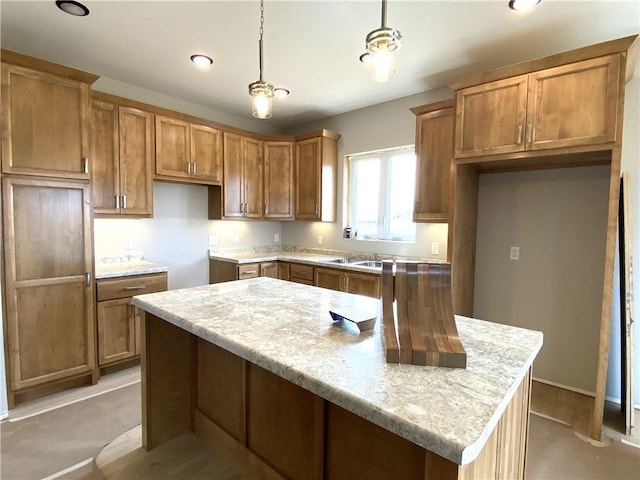4607 933rd St, Elk Mound, WI 54739 - kitchen featuring brown cabinetry, a kitchen island, hanging light fixtures, recessed lighting, and a sink