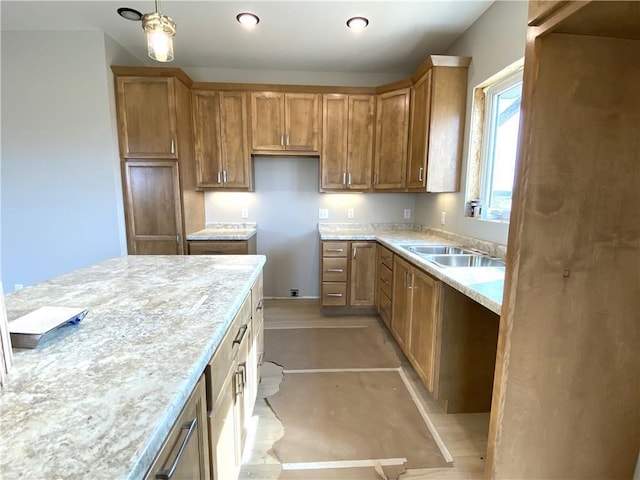 4607 933rd St, Elk Mound, WI 54739 - kitchen with brown cabinetry, decorative light fixtures, light countertops, a sink, and finished concrete floors