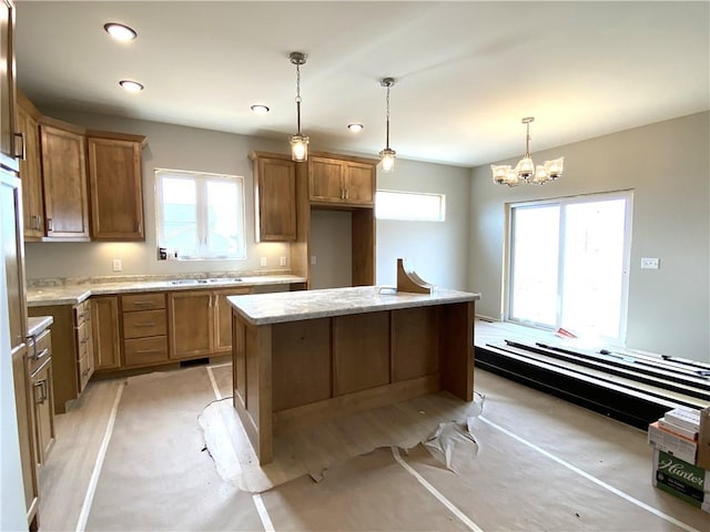 4607 933rd St, Elk Mound, WI 54739 - kitchen with a chandelier, decorative light fixtures, light stone counters, a kitchen island, and recessed lighting