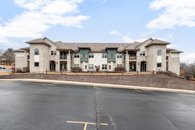 view of property with uncovered parking