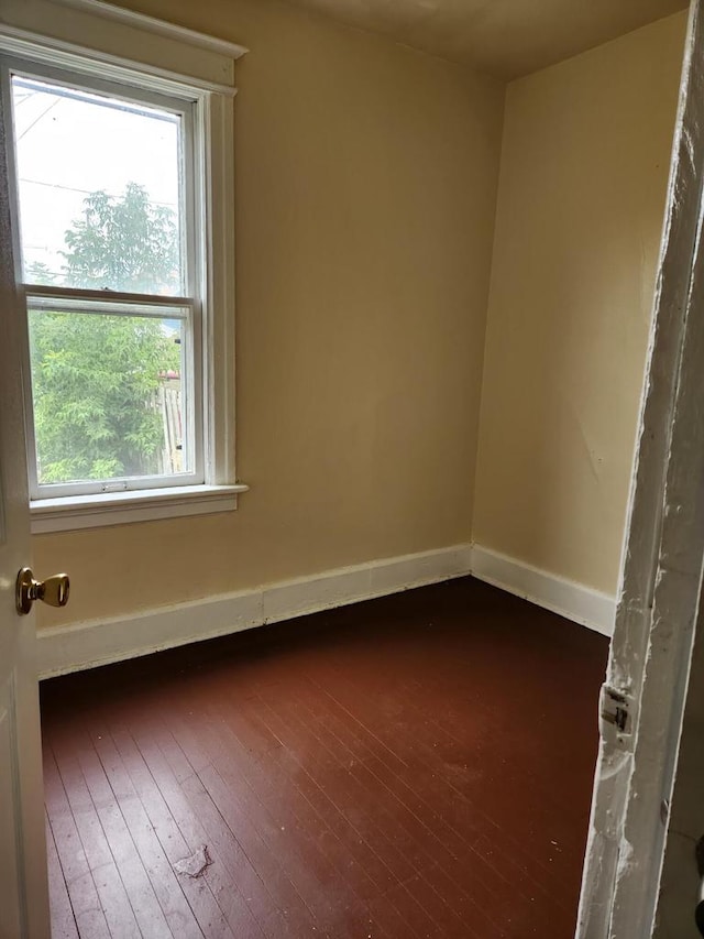 4047 N 19th St Unit 4049, Milwaukee, WI 53209 - unfurnished room with baseboards and dark wood-style flooring