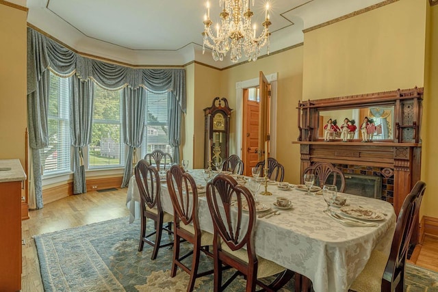 1222 11th St, Monroe, WI 53566 - dining space featuring a chandelier, wood finished floors, and crown molding