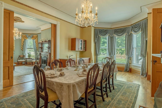 1222 11th St, Monroe, WI 53566 - dining space with a chandelier, wood finished floors, and crown molding