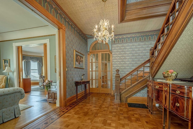1222 11th St, Monroe, WI 53566 - foyer with wallpapered walls, stairs, a chandelier, french doors, and baseboards