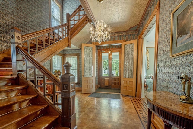 1222 11th St, Monroe, WI 53566 - entrance foyer featuring wallpapered walls, stairs, a chandelier, ornamental molding, and a towering ceiling