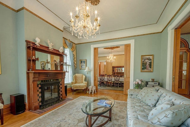 1222 11th St, Monroe, WI 53566 - living room featuring a chandelier, wood finished floors, a fireplace with flush hearth, and ornamental molding