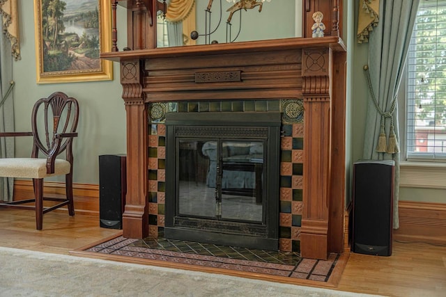 1222 11th St, Monroe, WI 53566 - detailed view of a fireplace, wood finished floors, and baseboards