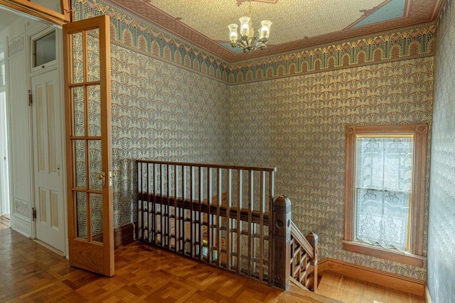 1222 11th St, Monroe, WI 53566 - stairs with wallpapered walls, a chandelier, and baseboards