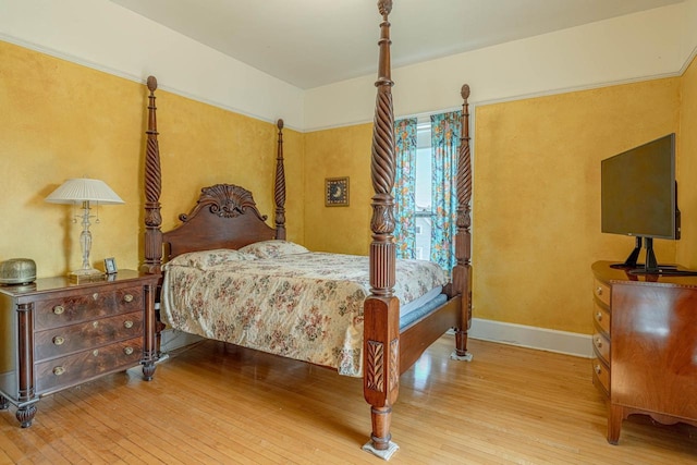 1222 11th St, Monroe, WI 53566 - bedroom with wood-type flooring and baseboards