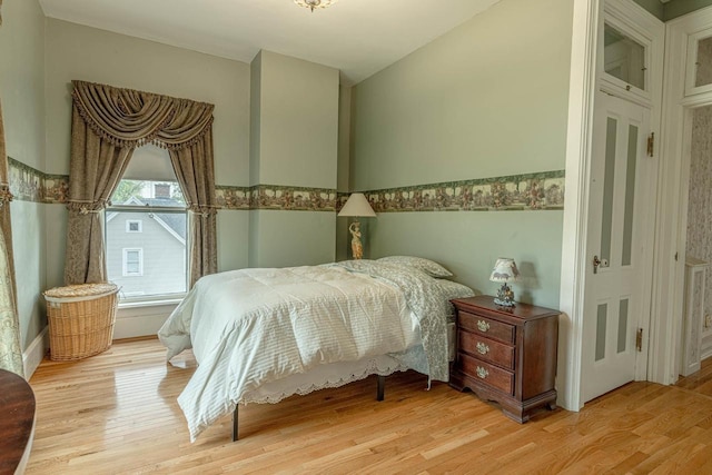 1222 11th St, Monroe, WI 53566 - bedroom with wood finished floors, vaulted ceiling, and wainscoting
