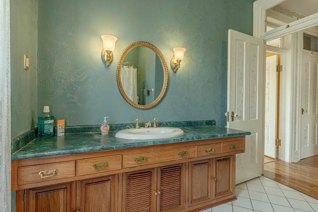 1222 11th St, Monroe, WI 53566 - full bath featuring vanity, tile patterned floors, and wallpapered walls