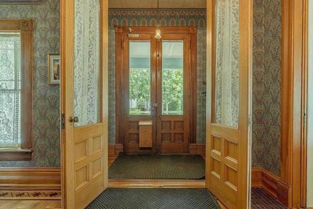 1222 11th St, Monroe, WI 53566 - doorway to outside featuring wallpapered walls, plenty of natural light, and baseboards