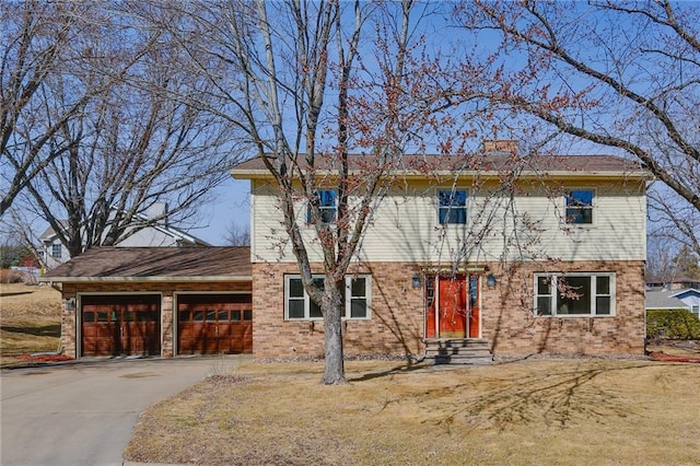 1353 Van Buren St, Black River Falls, WI 54615 - colonial-style house featuring concrete driveway, an attached garage, and a chimney