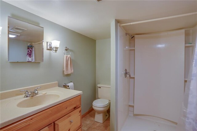 1353 Van Buren St, Black River Falls, WI 54615 - bathroom with curtained shower, toilet, vanity, and tile patterned flooring