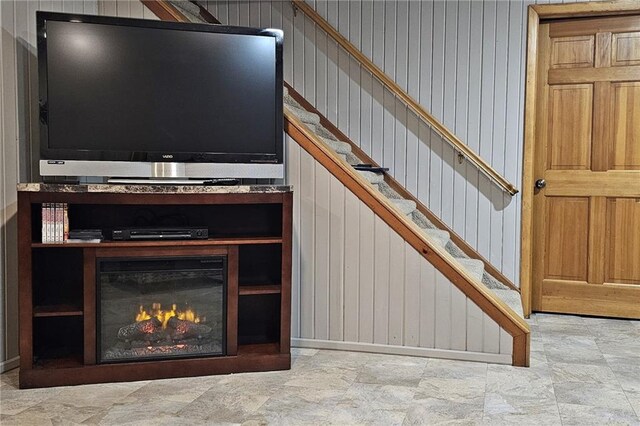 1353 Van Buren St, Black River Falls, WI 54615 - unfurnished living room featuring stairs and a lit fireplace