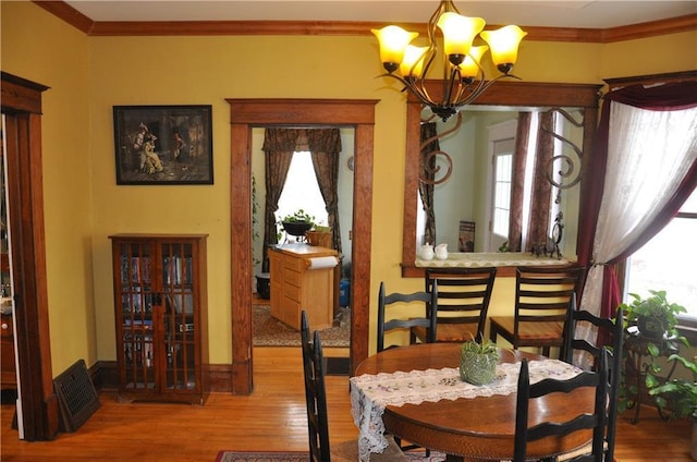 13600 8th St, Osseo, WI 54758 - dining space with crown molding, a notable chandelier, wood finished floors, and baseboards