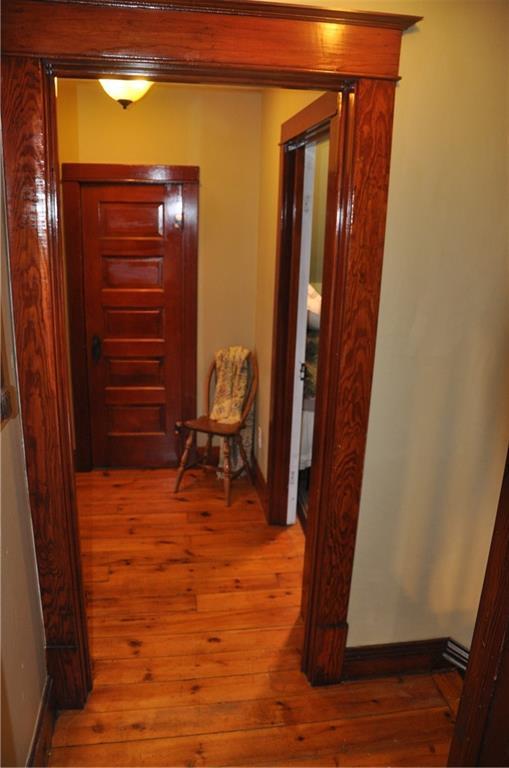 13600 8th St, Osseo, WI 54758 - corridor featuring wood-type flooring