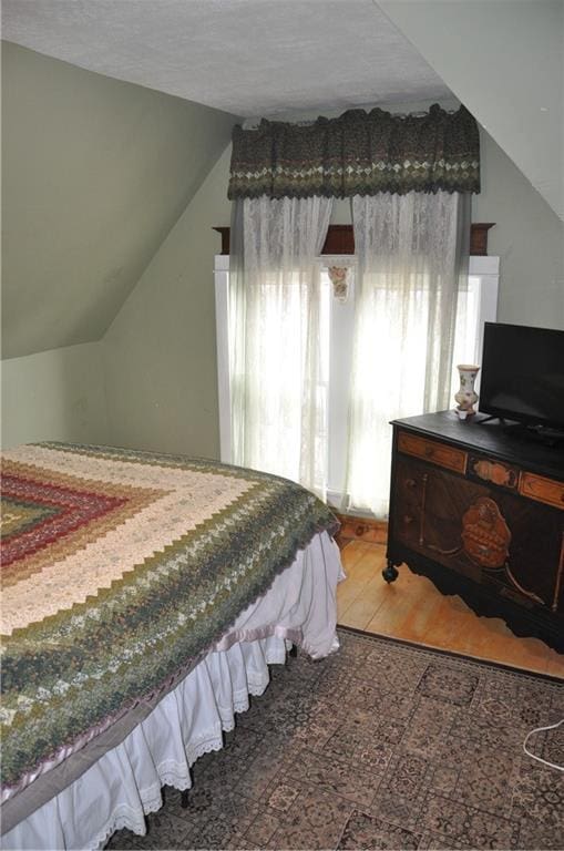 13600 8th St, Osseo, WI 54758 - bedroom featuring vaulted ceiling and wood finished floors