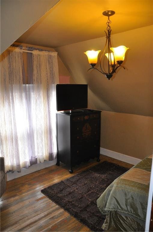 13600 8th St, Osseo, WI 54758 - bedroom featuring wood finished floors, a chandelier, and vaulted ceiling