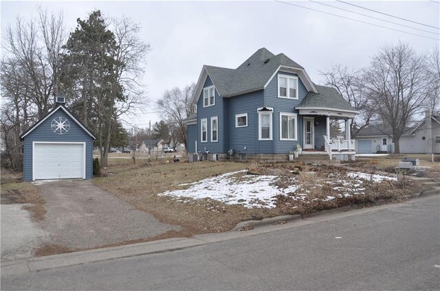 13600 8th St, Osseo, WI 54758 - view of front of house featuring a garage, a shingled roof, an outdoor structure, and aphalt driveway