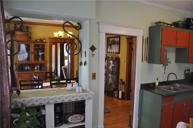13600 8th St, Osseo, WI 54758 - kitchen with a sink, a notable chandelier, wood finished floors, and crown molding