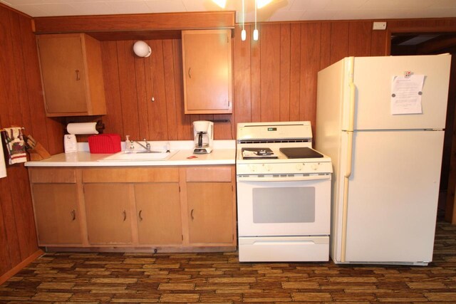1984 W 7th Dr, Friendship, WI 53934 - kitchen featuring wooden walls, white appliances, light countertops, and a sink