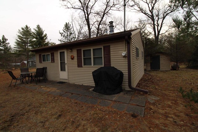 1984 W 7th Dr, Friendship, WI 53934 - back of house featuring an outbuilding and a patio
