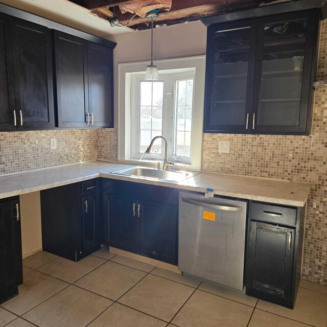 3731 S 56th St, Greenfield, WI 53220 - kitchen featuring stainless steel dishwasher, light countertops, light tile patterned flooring, and a sink