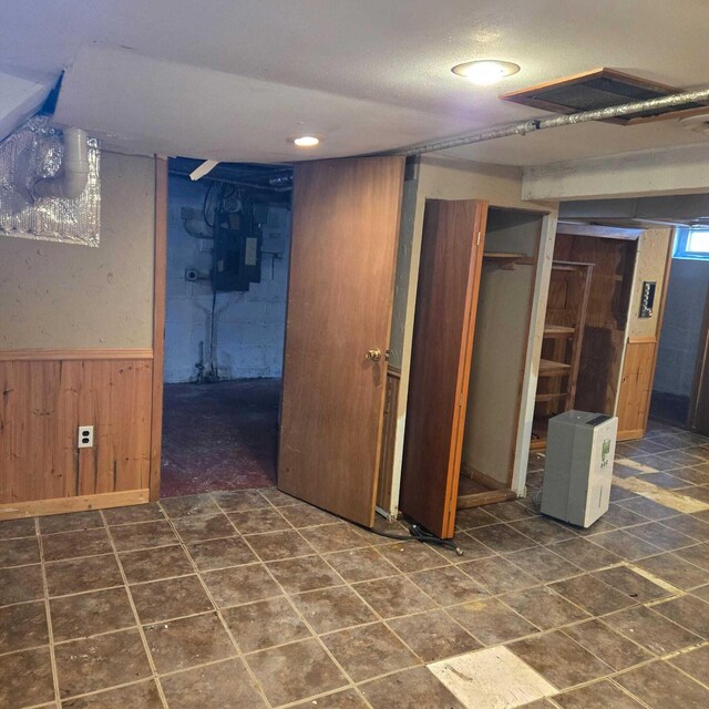 3731 S 56th St, Greenfield, WI 53220 - finished basement featuring a textured ceiling, wood walls, and wainscoting