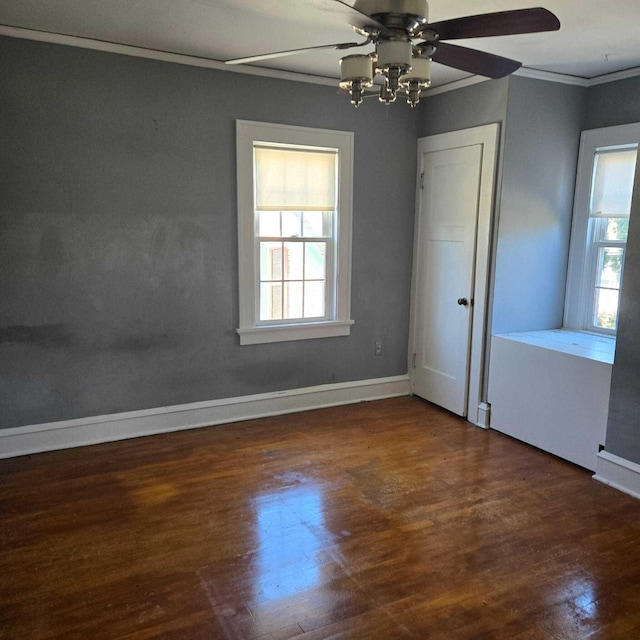 3731 S 56th St, Greenfield, WI 53220 - unfurnished bedroom with multiple windows, crown molding, baseboards, and wood finished floors