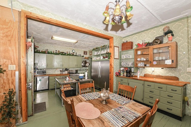 dining room featuring wallpapered walls and an inviting chandelier