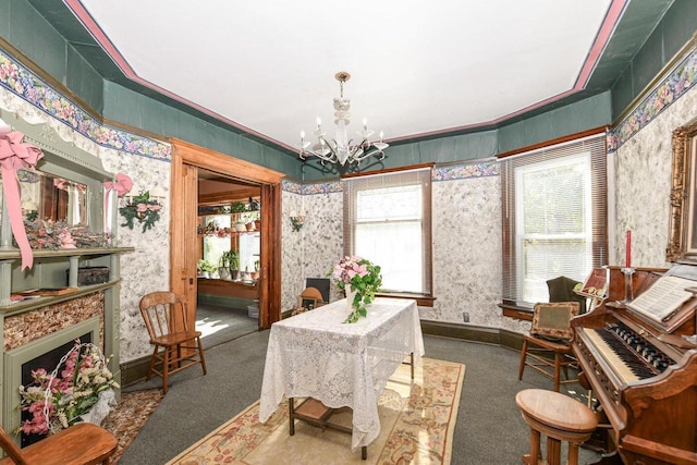 dining area with wallpapered walls, plenty of natural light, carpet floors, and a chandelier