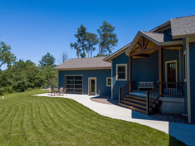 N9310 22nd Ave, Necedah, WI 54646 - rear view of property featuring a patio area, a shingled roof, and a yard