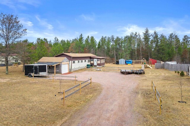 5830 Broadway St, Wisconsin Rapids, WI 54494 - view of front of house featuring a garage, driveway, and fence