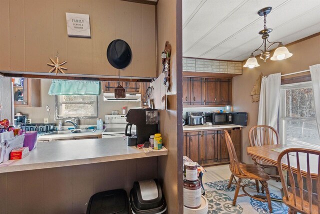 5830 Broadway St, Wisconsin Rapids, WI 54494 - kitchen featuring a wealth of natural light, brown cabinetry, and a sink